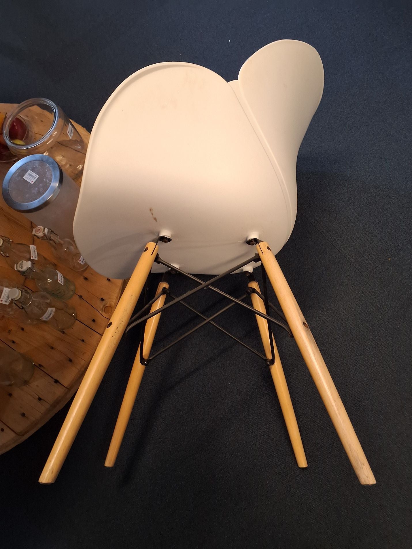 Stol i hvid plastik med træ ben